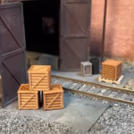 Photo of an HO Scale 3D printed model of packing crates and boxes for a model railroad