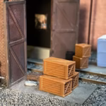 Photo of an HO Scale 3D printed model of packing crates and boxes for a model railroad