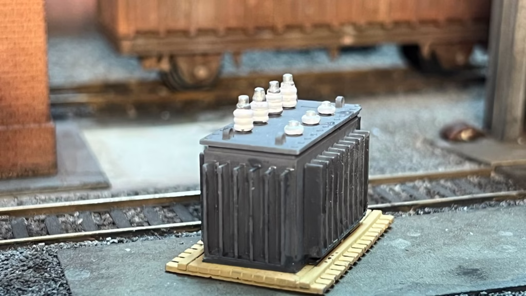 Photo of an HO Scale 3D printed model of a large electrical transformer for a model railroad