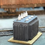 Photo of an HO Scale 3D printed model of a large electrical transformer for a model railroad