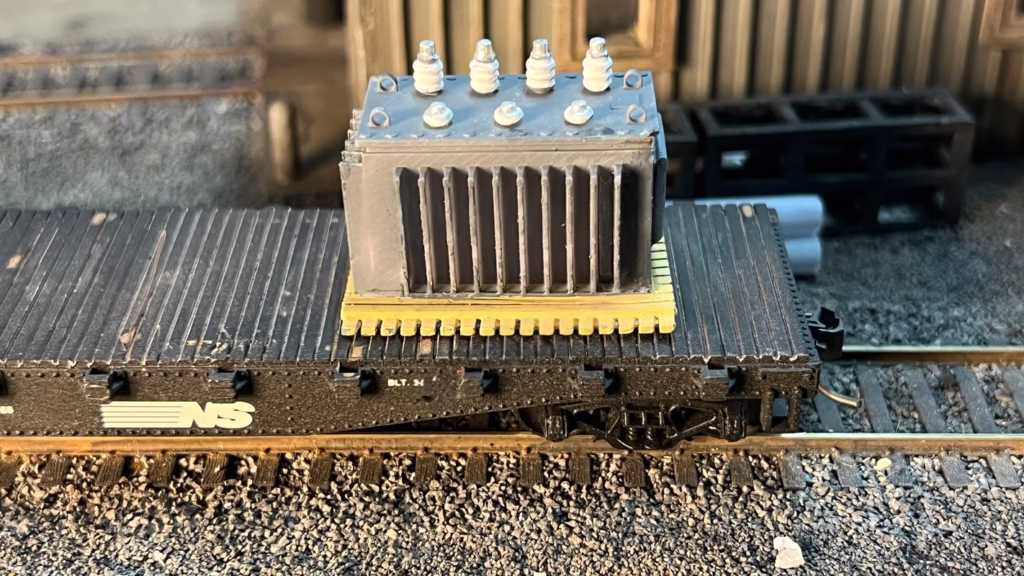 Photo of an HO Scale 3D printed model of a large electrical transformer for a model railroad