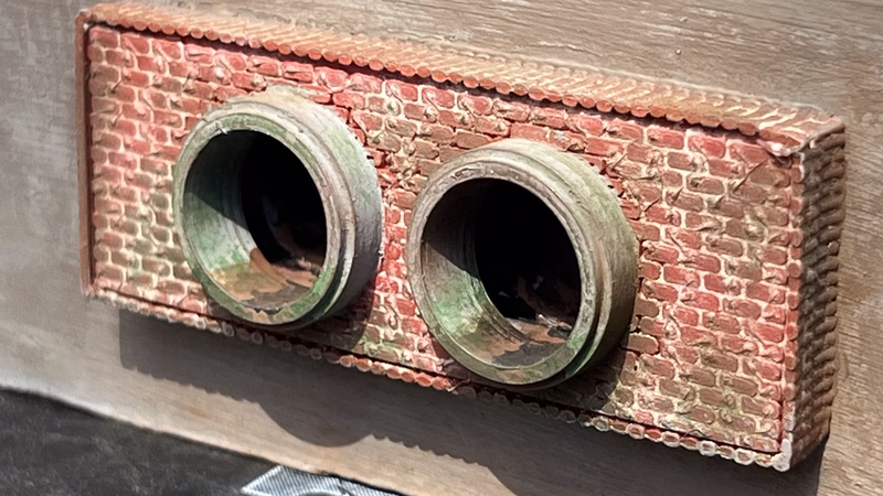 Photo of a HO Scale 3D printed model of a waste water drain outlet in brick for a model railroad