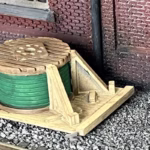 Photo of an HO Scale 3D printed model of a cable drum on a pallet for a model railroad