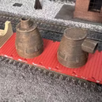 HO scale steel mill furnace hood with real rust detail on rail car top view