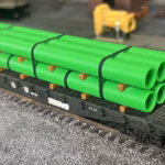 HO scale large pipe car load green corner view flat car - ScaleRail3D