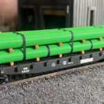 HO scale large pipe car load green left corner - ScaleRail3D