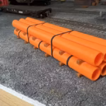 HO scale large pipe car load orange corner view - ScaleRail3D